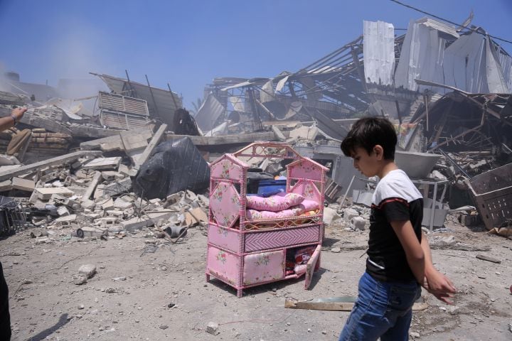 A Palestinian boy near the ruins of his house after an Israeli airstrike in Gaza City, Gaza Strip, May 14, 2021. (Samar Abu Elouf/The New York Times)