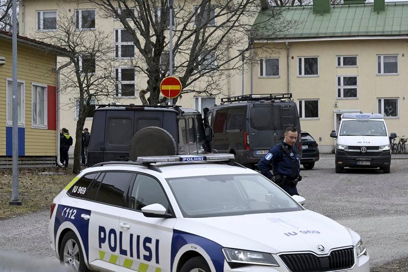 Police officers and vehicles at the scene of Viertola comprehensive school, in Vantaa, Finland, Tuesday, April 2, 2024. Finnish police say a number of people were wounded in a shooting at a school outside Helsinki and a suspect was detained. (Markku Ulander/Lehtikuva via AP)