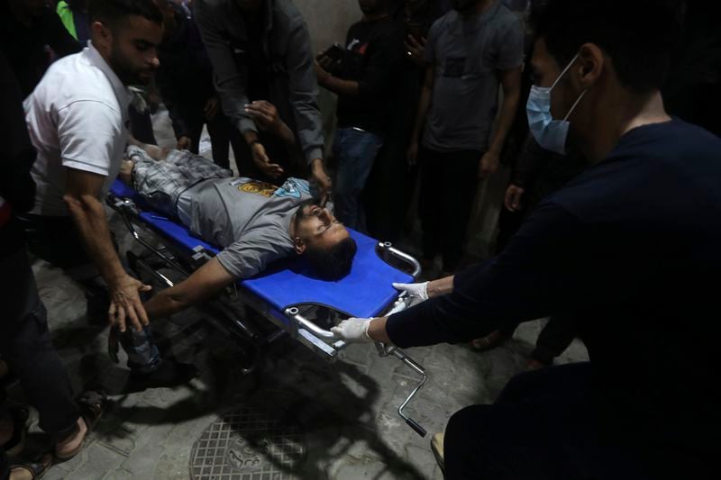 A Palestinian wounded in the Israeli bombardment of the Gaza Strip is brought to the Kuwaiti Hospital in Rafah refugee camp, southern Gaza Strip, early Saturday, April 20, 2024. (AP Photo/Ismael Abu Dayyah)