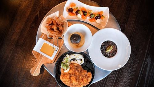 Young Beets, Black Rice & Oxtail Risotto, Pork Schnitzel, Crispy Chicken Skins, Glazed Donut Bread Pudding (center).  (Contributed by Chris Hunt Photography)