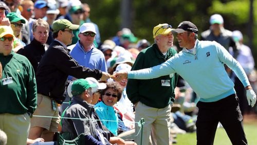 April 7, 2017 AUGUSTA Matt Kuchar hands cash to a fan after his ball hit the fan on the 13th hole and bounced back into the fairway. Play begins in the second round of the 81st Masters tournament at the Augusta National Golf Club, Friday April 7, 2017. CURTIS COMPTON/ AJC