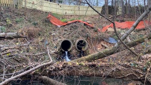 The existing stormwater pipe adjacent to Old Alabama Road in Johns Creek has no headwall. Without a headwall to properly handle the velocity of the water exiting the pipe, the ground under and around the pipe has become heavily eroded. (Courtesy City of Johns Creek)
