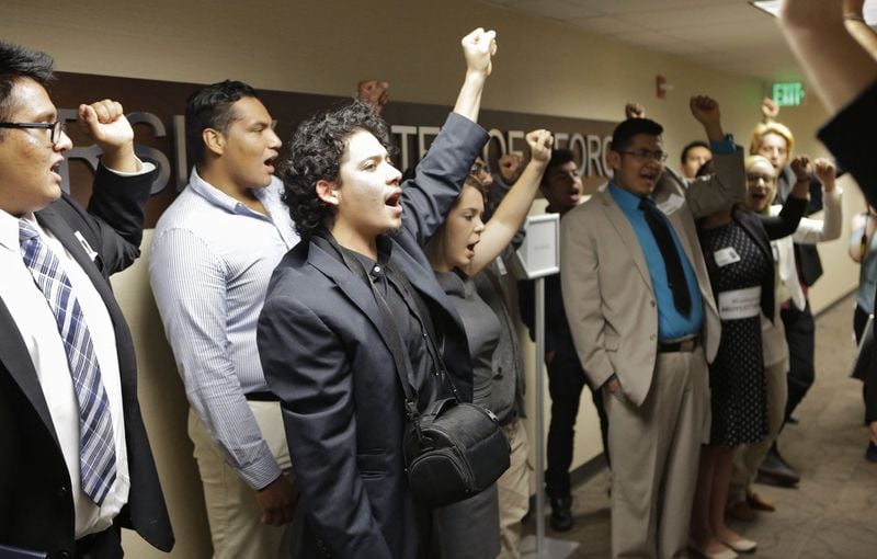 Protestors occupied and chanted in the Board of Regents seats during a March 2016 meeting, then marched around the 8th floor, before some of them returned to the seats and were arrested. The students protested Georgia’s tuition policies that require undocumented students to pay more expensive out-of-state tuition at Georgia’s public colleges. BOB ANDRES / BANDRES@AJC.COM