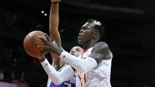 Atlanta Hawks guard Dennis Schroder, right, drives to the basket against Sacramento Kings guard George Hill, left,  during the first half of an NBA basketball game Wednesday, Nov. 15, 2017, in Atlanta. (AP Photo/John Bazemore)