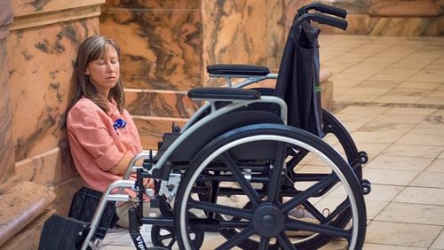 Liz Burlingame of Dunwoody is pictured near her wheelchair at the state Capitol, where a Millions Missing rally was held last year to increase awareness about chronic fatigue syndrome, also known as myalgic encephalomyelitis or ME/CFS. Burlingame, 49, was diagnosed with the disease when she was 24. CONTRIBUTED