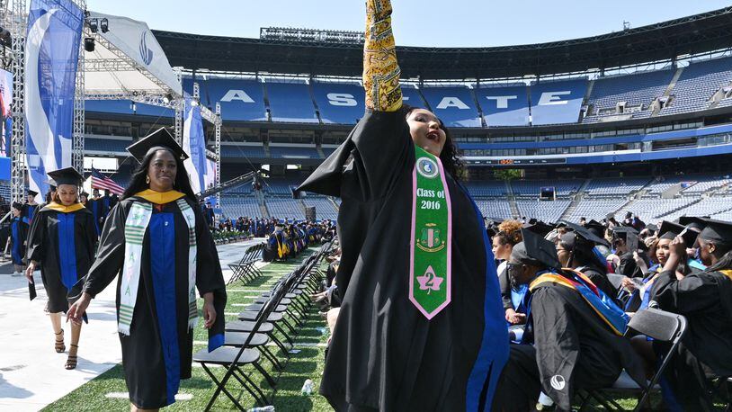 A graduate waves to family members and friends during the May 2022 Georgia State University's master’s degree commencement ceremony at Center Parc Stadium. A 2019 report by the U.S. House Committee on Education and Labor found that for every dollar states invest in higher education, they receive up to $4.50 back in increased tax revenue and lower reliance on government assistance. (Hyosub Shin / Hyosub.Shin@ajc.com)
