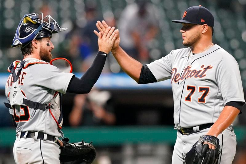 Detroit Tigers relief pitcher Joe Jimenez, right, and catcher Eric Haase celebrate after the Tigers defeated the Cleveland Indians 7-1 in the second baseball game of a doubleheader, early Thursday, July 1, 2021, in Cleveland. (AP Photo/Tony Dejak)