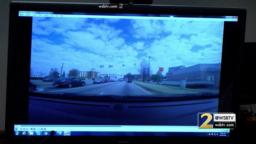 In this GoPro camera video, Cobb County lead detective Phil Stoddard demonstrates the route taken by Justin Ross Harris on the day that Cooper died. In this view, the vehicle is on Cumberland Parkway and approaching the intersection with Paces Ferry Road. The vehicle is in the lane to go straight through to the Home Depot Treehouse rather than in the left lane, which would take the driver to the Little Apron Academy. The video was shown to the jury during murder trial of Justin Ross Harris at the Glynn County Courthouse in Brunswick, Ga., on Monday, Oct. 24, 2016. (screen capture via WSB-TV)