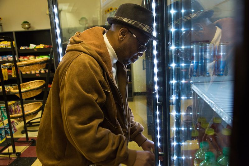 Eddie Mial checks stock in the cooler by touch at his shop at the DeKalb County Courthouse. (Photo by Phil Skinner)
