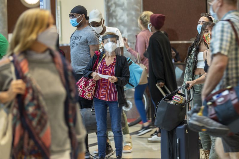 09/04/2020 -Atlanta, Georgia - A woman wearing a face shield and a face mask arrives from her flight into the domestic terminal at Hartsfield-Jackson Atlanta International Airport, Friday, September 4, 2020. (Alyssa Pointer / Alyssa.Pointer@ajc.com)