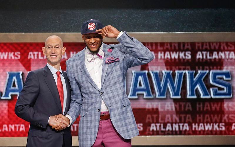 Michigan State's Adreian Payne, right, poses for a photo with NBA commissioner Adam Silver after being selected as the 15th overall pick by the Atlanta Hawks during the 2014 NBA draft, Thursday, June 26, 2014, in New York. (AP Photo/Jason DeCrow) Props for the plaid and the pink, Mr. Payne. (Jason DeCrow/AP)
