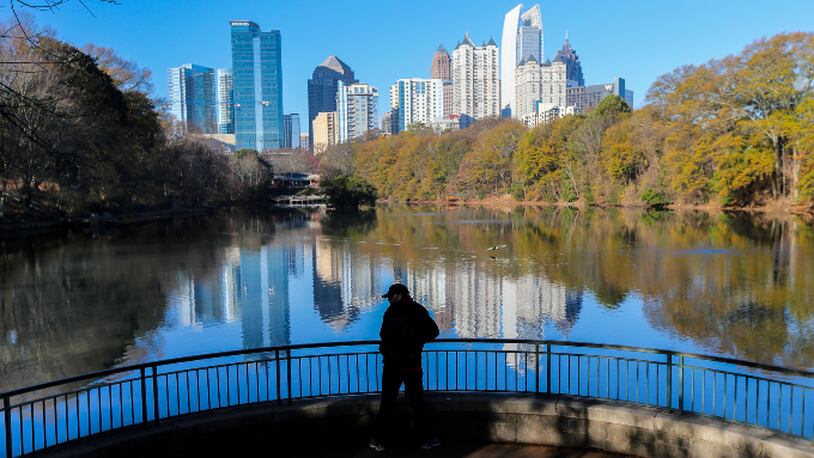 Midtown Atlanta’s skyline reflected in Lake Clare Meer at Piedmont Park on the first day of winter, Wednesday, Dec. 21, 2016.