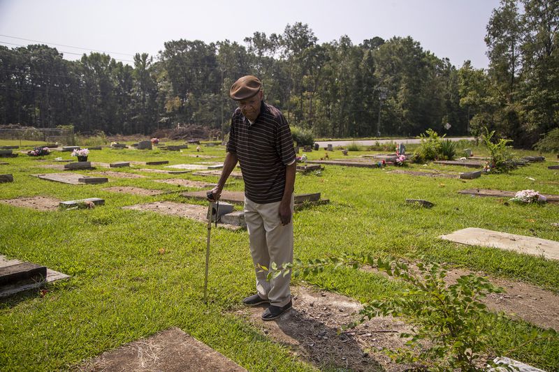 07/27/2021 — Millbrook, Alabama — James Postell searches for the grave of his cousin, Pvt. Felix Hall, at Goodship Cemetery in Millbrook, Tuesday, July 27, 2021. (Alyssa Pointer/Atlanta Journal Constitution)