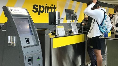 Passengers seek assistance at the Spirit Airlines check-in counter at Hartsfield-Jackson.