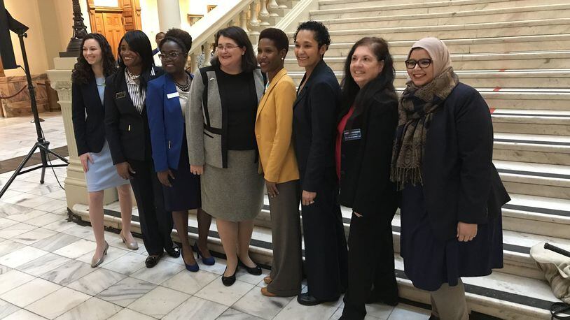 State House and Senate candidates (from left) Beth Moore, Donna McLeod, Jasmine Clark, Zahra Karinshak, Tamara Johnson-Shealey, Shelly Hutchinson, Andrea Stephenson and Aisha Yaqoob pose for a photo at the Capitol before qualifying on March 6. All eight women are Democrats and are running for seats based in Gwinnett County. TYLER ESTEP / TYLER.ESTEP@AJC.COM