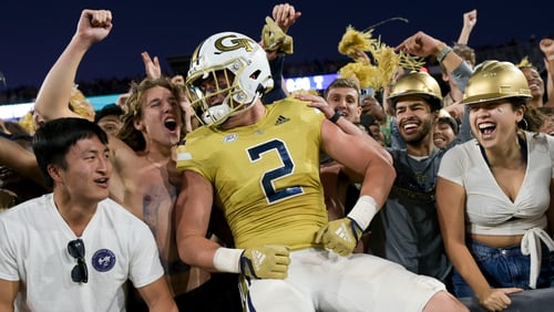 Georgia Tech’s Dylan Leonard celebrates with fans after the Yellow Jackets defeated Duke 23-20 in overtime Saturday at Bobby Dodd Stadium. (Daniel Varnado/For the AJC)