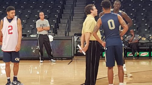 With fan Ron Bell standing in the background, Georgia Tech men’s basketball coach Josh Pastner speaks to players during practice. CONTRIBUTED