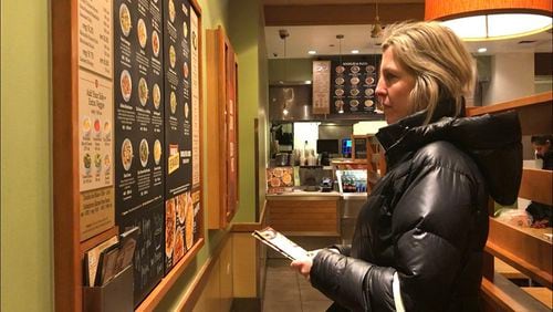 Bethany Doerfler, a registered dietitian at the Digestive Health Center at Northwestern Medicine, looks at a menu at Noodles and Co. (Grace Wong/Chicago Tribune/TNS)