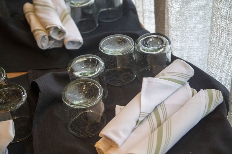Glassware and silverware will be placed on the table after a guest has sat down for in-person dining at the Select restaurant and bar in Sandy Springs. Until the guests arrive, glassware is facing down and out of reach to others. ALYSSA POINTER / ALYSSA.POINTER@AJC.COM