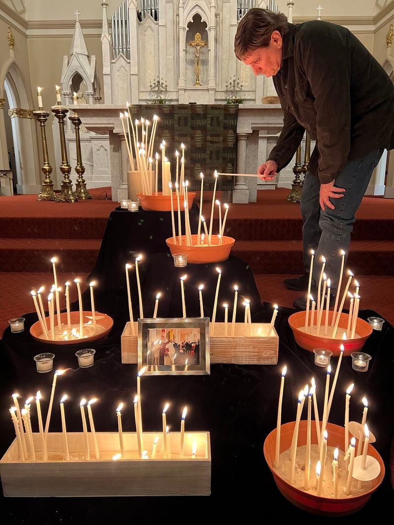 Father Joseph Morris
lights a candle during a vigil for Monsignor Henry C. Gracz, the pastor of the historic Catholic Shrine of the Immaculate Conception in downtown Atlanta. Gracz died Monday at age 84. (Kelly Quindlen)