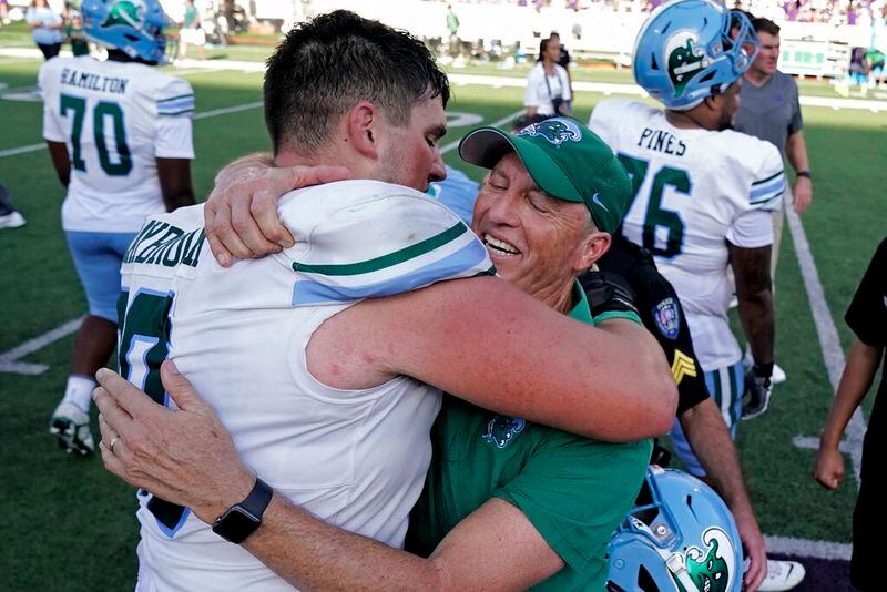 Tulane head coach Willie Fritz celebrates with offensive lineman Joey Claybrook after their NCAA college football game against Kansas State Saturday, Sept. 17, 2022, in Manhattan, Kan. Tulane won 17-10. (AP Photo/Charlie Riedel)