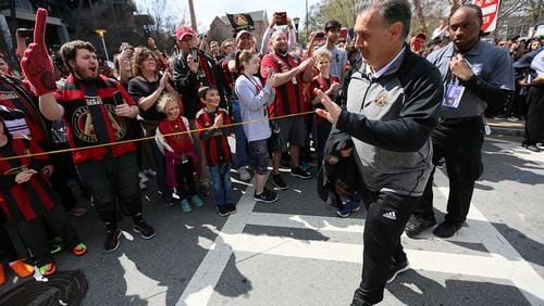 Atlanta United fans greet the team, including manager Gerardo Martino, as they arrived at Georgia Tech’s Bobby Dddd Stadium for the second home game of the season against the Chicago Fire. (Miguel Martinez / Mundo Hispanico)