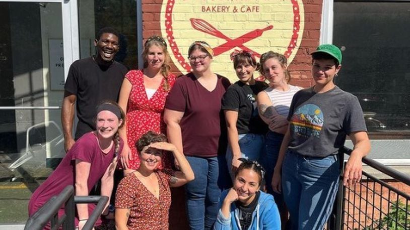 To cover health care costs, owner Sarah O’Brien (front row, second from left) has added a 4% pre-tax fee to transactions at her Little Tart Bakeshop locations and farmers market stalls, as well as her Big Softies ice cream shop. Courtesy of Madi Bolton/Little Tart Bakeshop