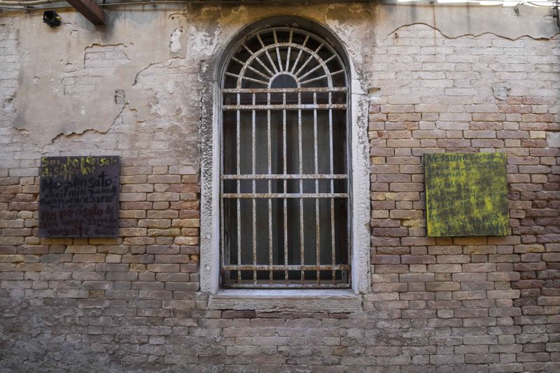 An installation by artist Simone Fattal is displayed inside the women's prison at the Giudecca island during the 60th Biennale of Arts exhibition in Venice, Italy, Wednesday, April 17, 2024. A pair of nude feet dirty, wounded and vulnerable are painted on the façade of the Venice women's prison chapel, the work of Italian artist Maurizio Cattelan and part of the Vatican's pavilion at the Venice Biennale in an innovative collaboration between inmates and artists. (AP Photo/Luca Bruno)