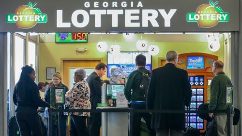 Lines formed outside at the Georgia Lottery Airport South Kiosk at Hartsfield-Jackson International Airport on Tuesday, Jan. 12, 2016 as the record-breaking Powerball jackpot continued to climb, hitting $1.5 billion ahead of Wednesday's drawing, according to the Georgia Lottery. JOHN SPINK /JSPINK@AJC.COM