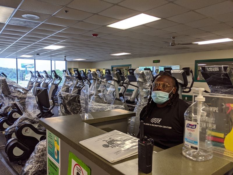 Juwon Merritt, 23, exercise science major, at his job at the Ga Gwinnett fitness center. Most of the cardio machines are shrink-wrapped to maintain social distancing between the operational machines. TY TAGAMI/AJC