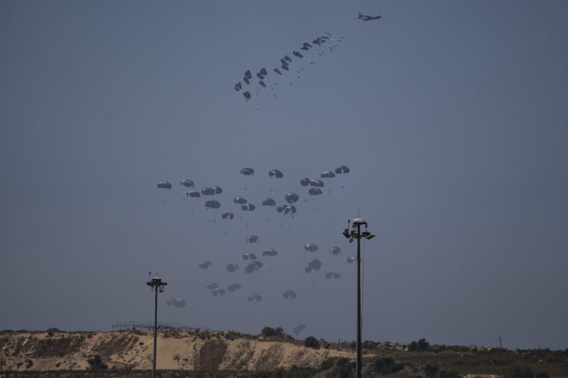An aircraft airdrops humanitarian aid over northern Gaza Strip as seen from southern Israel, Thursday, April 4, 2024. (AP Photo/Leo Correa)