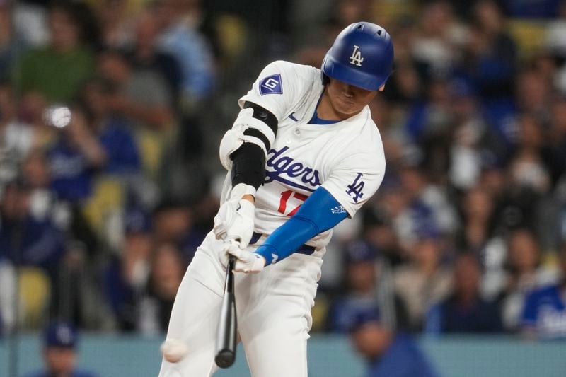 Los Angeles Dodgers designated hitter Shohei Ohtani singles during the fourth inning of a baseball game against the Miami Marlins in Los Angeles, Monday, May 6, 2024. (AP Photo/Ashley Landis)