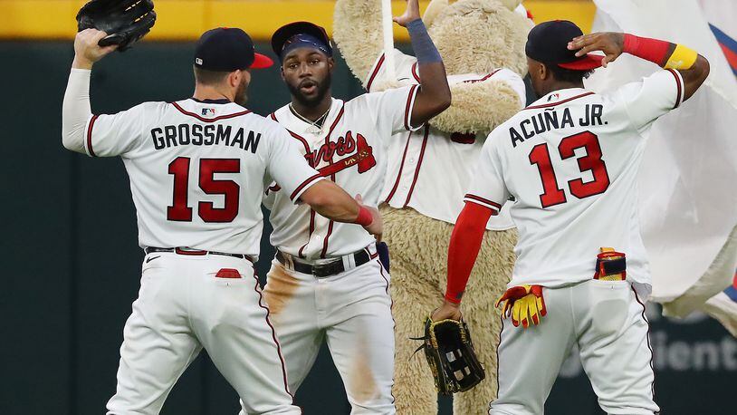 Atlanta Braves outfielders Robbie Grossman (from left), Michael Harris, and Ronald Acuna celebrate a 3-2 victory over the New York Mets to take the series in a MLB baseball game on Thursday, Aug. 18, 2022, in Atlanta.   “Curtis Compton / Curtis Compton@ajc.com