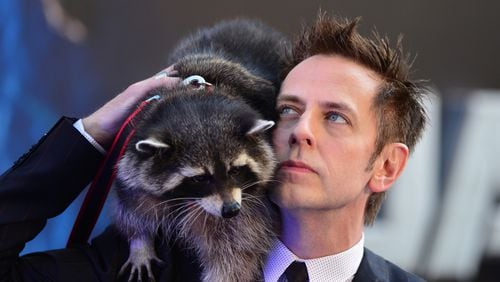 Director James Gunn (R) and Oreo the raccoon attend the European premiere of the film, Guardians of the Galaxy in central London on July 24, 2014.
