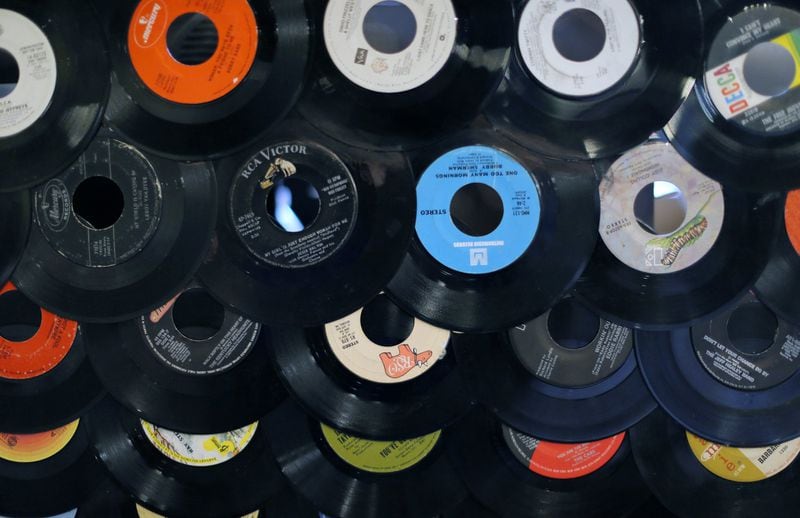 One of the displays at local independent record store Criminal Records, located in Little Five Points, is decorated with old 45s. The store will be among more than 20 metro Atlanta businesses that will participate in the 10th annual Record Store Day on April 22. BOB ANDRES / BANDRES@AJC.COM