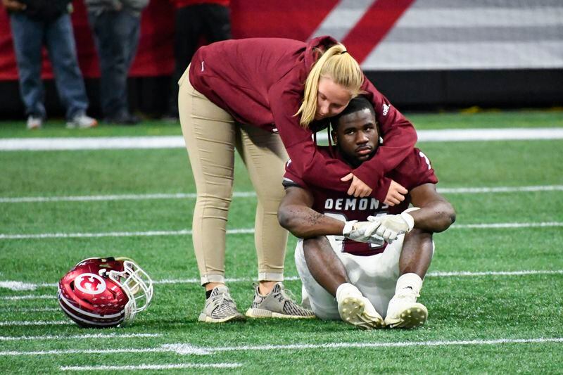 Warner Robins running back Jahlen Rutherford is consoled  after the loss in the Class AAAAA championship.