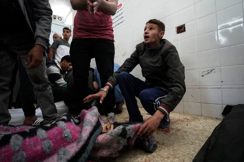 A Palestinian reacts to seeing the young victim of an Israeli airstrike, at Al Aqsa Hospital in Deir al Balah, central Gaza Strip, Monday, April 22, 2024. (AP Photo/Abdel Kareem Hana)