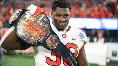 Clemson defensive tackle Ruke Orhorhoro (33) reacts after defeating North Carolina during the Atlantic Coast Conference championship NCAA college football game on Saturday, Dec. 3, 2022, in Charlotte, N.C.  The Falcons picked Orhorhoro in the second round of the NFL draft Friday. (AP Photo/Jacob Kupferman)