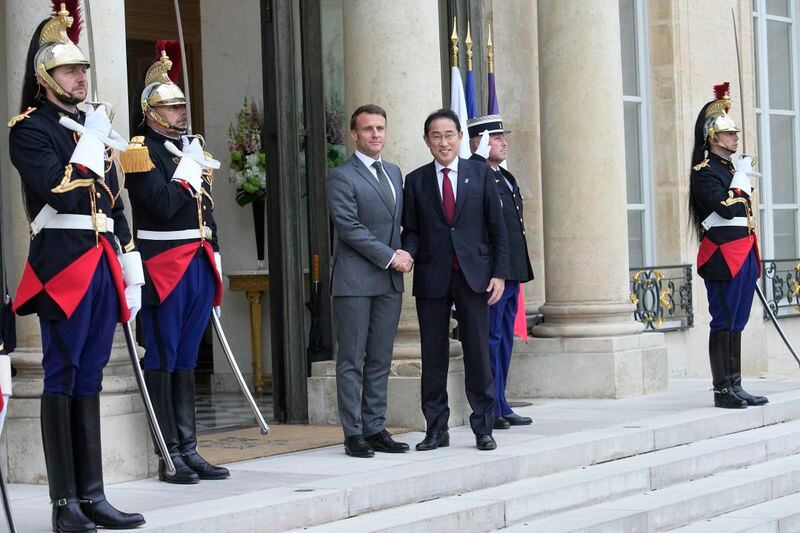 French President Emmanuel Macron, center left, shakes hands with Japanese Prime Minister Fumio Kishida before a working lunch, Thursday, May 2, 2024 at the Elysee Palace in Paris. (AP Photo/Michel Euler)