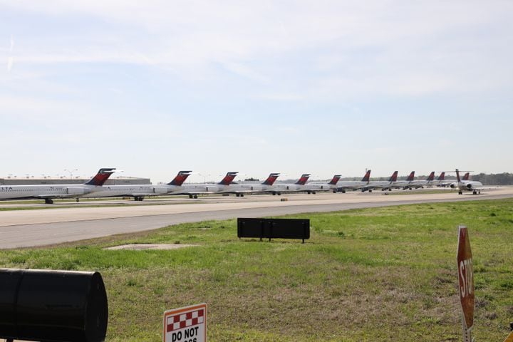 Flight cuts: Delta planes parked on Atlanta airport runway, taxiways