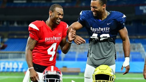 Terry Godwin II #4 from Georgia and Justin Hollins #48 from Oregon  joke around before accepting the offensive and defensive MVP honors at the 2019 East-West Shrine Game at Tropicana Field on January 19, 2019 in St Petersburg, Florida. (Photo by Julio Aguilar/Getty Images)