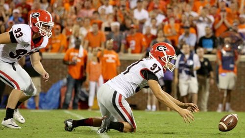 University of Georgia holder Adam Erickson (97) mishandles the snap as kicker Patrick Beless, left, looks on during a failed field goal attempt in the second half of their game against Clemson University at Memorial Stadium Saturday night in Clemson, SC., August 31, 2013. Clemson defeated Georgia 38-35. JASON GETZ / JGETZ@AJC.COM