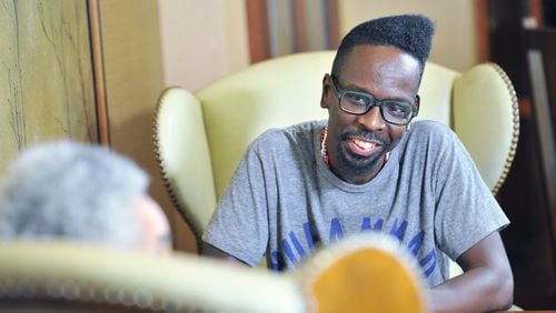 September 15, 2016 Atlanta - Atlanta based artist Fahamu Pecou reacts as he listens to filmmaker, sculptor and provocateur Camille Billops (foreground) at Emory University Conference Center Hotel on Thursday, September 15, 2016. Both have made careers exploring black identity and representation in art. Pecou’s work is in the permanent collection of the new Smithsonian African American musuem, Billops’ work is taught in colleges around the country.