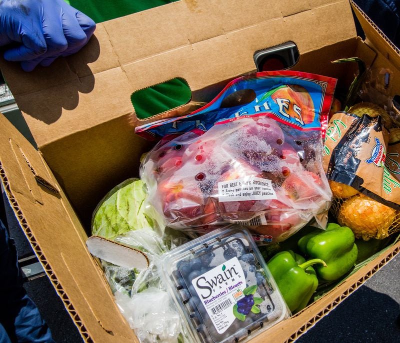 The boxes of produces included onions, peaches, blueberries, bell peppers, cabbage and more. (Jenni Girtman for Atlanta Journal Constitution)