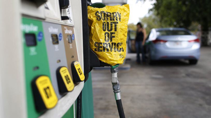 A “Sorry out of Service” sign is placed on one of the gas pumps at a gas station in Athens, Ga., on Friday, Sept. 1, 2017. Gasoline prices in the U.S. have risen to new high amid continuing fears of shortages in Texas and other states after Hurricane Harvey’s strike. (Joshua L. Jones/Athens Banner-Herald via AP)