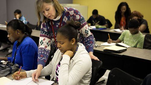 Instructor Margaret Robling (standing) helps Isatu Jalloh (right) during a GED preparation class at Georgia Piedmont Technical College. Georgia Piedmton is part of the Technical College System of Georgia, which has started a new program to help more adults without a high school diploma get their credentials. PHOTO CONTRIBUTED.