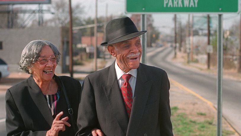 Louise Hollowell and her husband Donald Lee Hollowell standing at a road sign in Atlanta designating that Bankhead Highway had been renamed in Hollowell’s honor. Hollowell, an Atlanta attorney who died in 2004 at age 87, was a giant in the field of civil rights law. (Photo: Dec. 3, 1998/Nick Arroyo/AJC file)