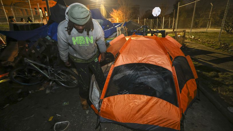 Todd Rick, 31, who is homeless, gets into his tent that he lives in at an encampment near the Mechanicsville neighborhood, Monday, Jan. 23, 2023, in Atlanta. Rick and two other men, who are homeless, were interviewed by a group of volunteers and staff from supporting agencies as a part of the PIT, (Point-In-Time) count, a practice mandated by the federal government that tallies people who were homeless on one night in January of each year. Jason Getz / Jason.Getz@ajc.com)