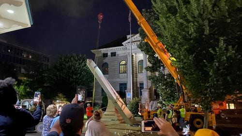 A 30-foot obelisk Confederate moment, which has stood for 112 years, was taken down in the downtown Decatur square late Thursday night. The monument was erected in 1908 by the United Daughters of the Confederacy. Photos by Amanda Coyne / AJC