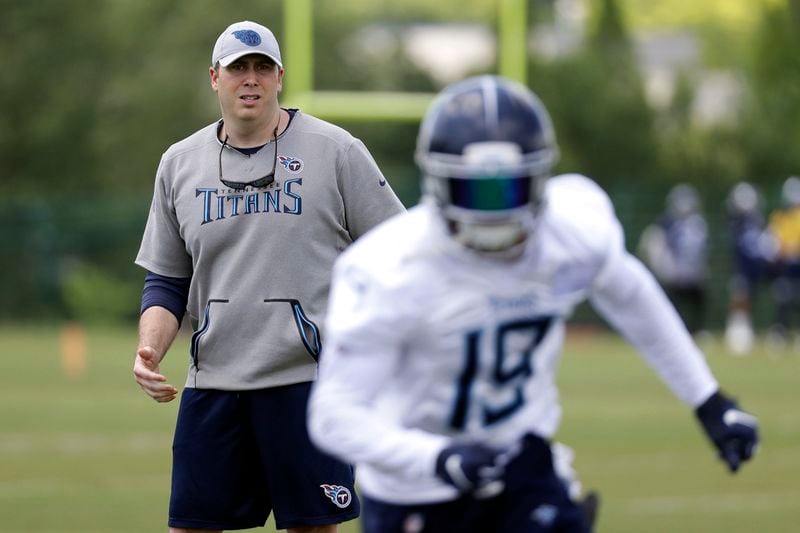 Tennessee Titans offensive coordinator Arthur Smith, left, watches as wide receiver Tajae Sharpe (19) runs a drill during an organized team activity at the Titans' NFL football training facility Tuesday, May 21, 2019, in Nashville, Tenn. (AP Photo/Mark Humphrey)